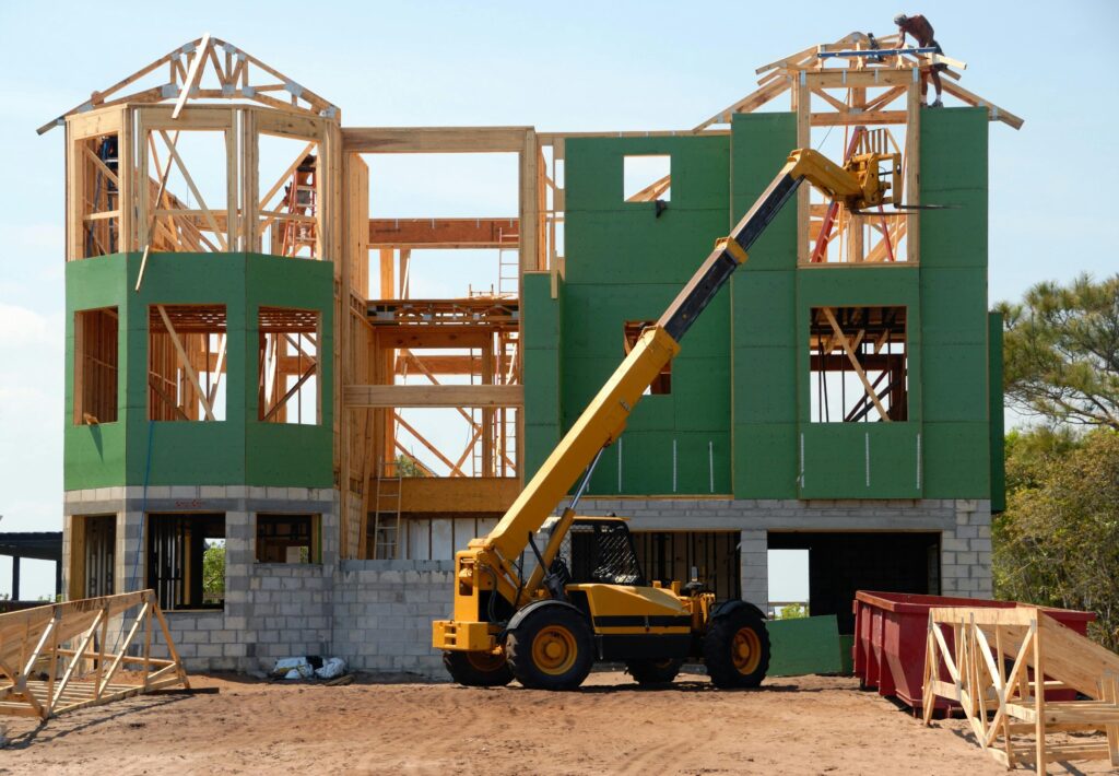 pexels-photo-534220-534220 A multi-story wooden house under construction using a crane on a sunny day.
